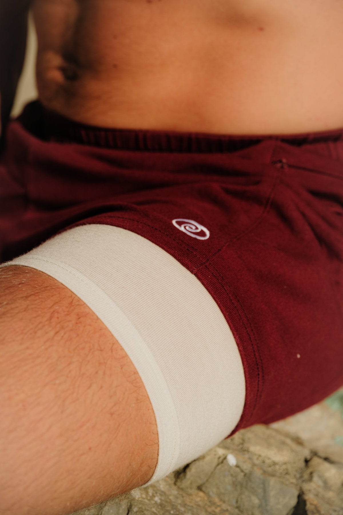 Close detail of a Wayve Quad Short: organic cotton outer shell over a merino wool liner
